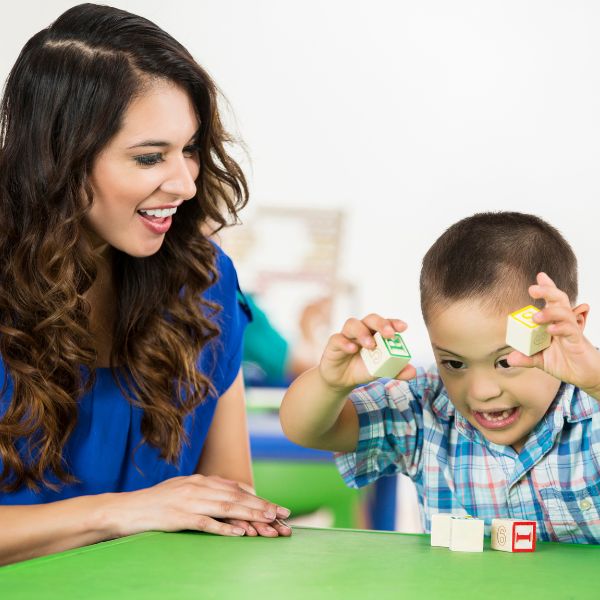 Therapist watching while a child plays with blocks