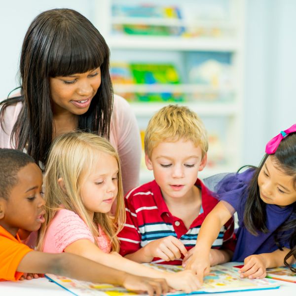 A teacher helping a group of students