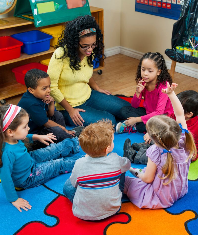 preschool students gathered on a rug