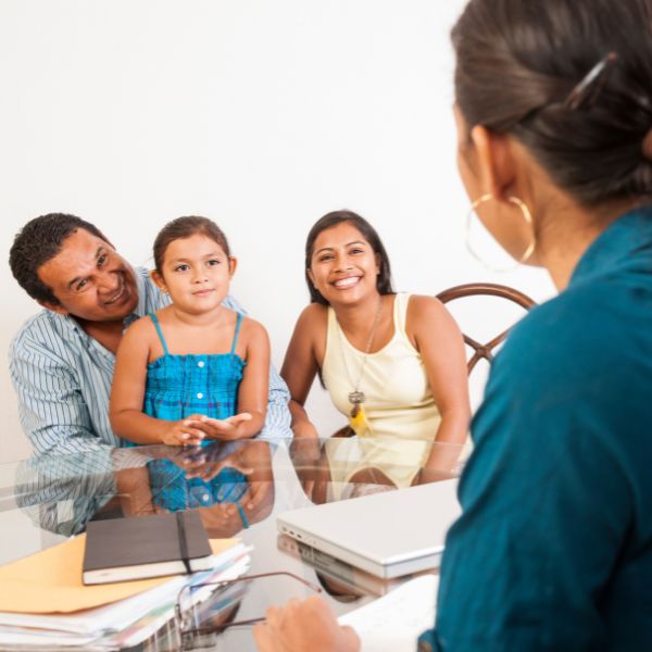 Therapist having a discussion with a family who needs help